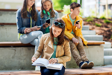 Image showing high school student girl reading book outdoors