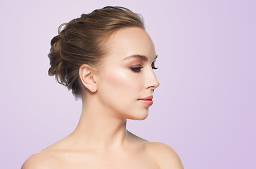 Image showing beautiful young woman face over violet background