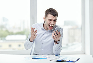 Image showing close up of businessman with smartphone