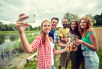 Image showing happy friends taking selfie by smartphone