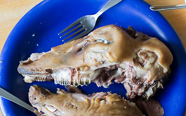 Image showing Boiled sheep\'s head on a blue plate - Selective focus on teeth