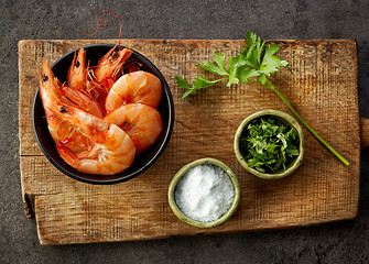 Image showing roasted prawns on wooden cutting board