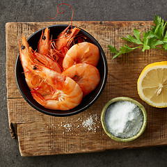 Image showing roasted prawns on wooden cutting board