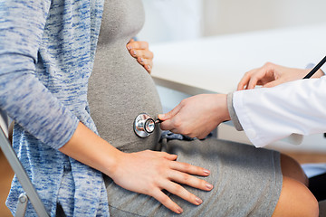 Image showing doctor with stethoscope and pregnant woman belly