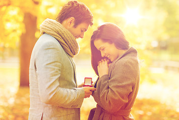 Image showing man proposing to a woman in the autumn park