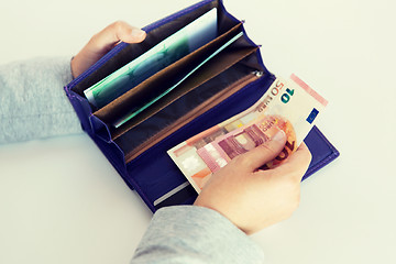 Image showing close up of woman hands with wallet and euro money