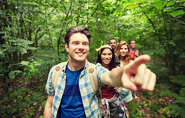 Image showing group of smiling friends with backpacks hiking
