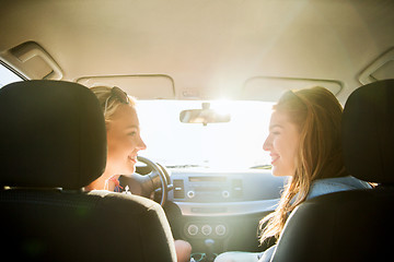 Image showing happy teenage girls or women in car at seaside