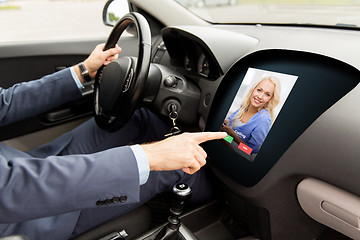 Image showing close up of man driving car and receiving call