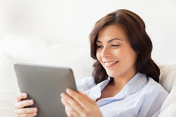 Image showing smiling woman with tablet pc at home