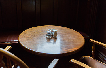 Image showing close up of vintage table and chairs in irish pub