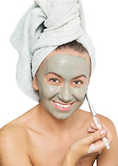 Image showing woman applying mask