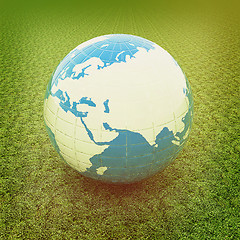 Image showing Earth on green grass. 3D illustration. Vintage style.