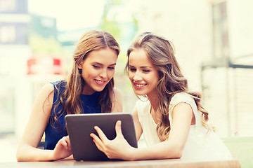 Image showing happy young women with tablet pc at outdoor cafe