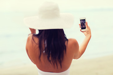 Image showing smiling young woman taking selfie with smartphone