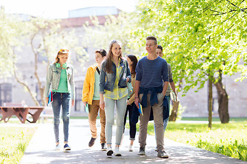Image showing group of happy teenage students walking outdoors