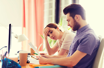 Image showing creative team with reading paper in office