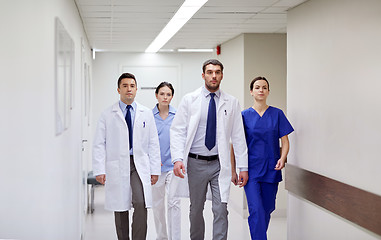 Image showing group of medics walking along hospital