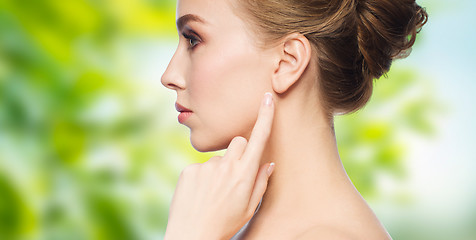 Image showing beautiful woman pointing finger to her ear