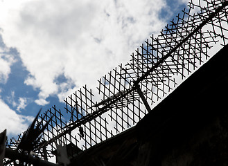 Image showing close up of fence with barbed wire and mesh