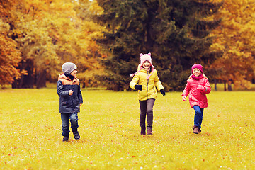 Image showing group of happy little kids running outdoors