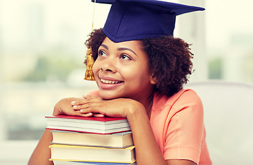 Image showing happy african bachelor girl with books at home