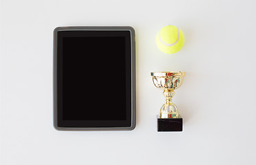 Image showing close up of tennis ball, cup and tablet pc