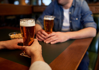 Image showing close up of men drinking beer at bar or pub