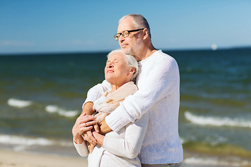 Image showing happy senior couple hugging on summer beach