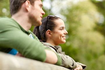 Image showing smiling couple with backpacks on bridge in nature