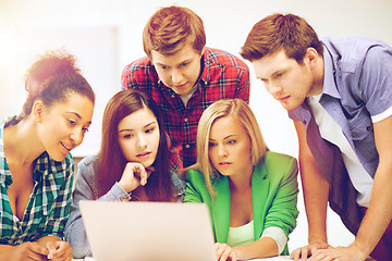 Image showing international students looking at laptop at school