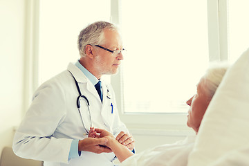 Image showing doctor checking senior woman pulse at hospital