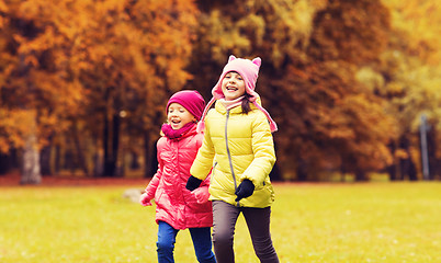 Image showing group of happy little girls running outdoors