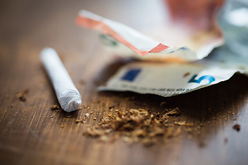 Image showing close up of marijuana joint and money