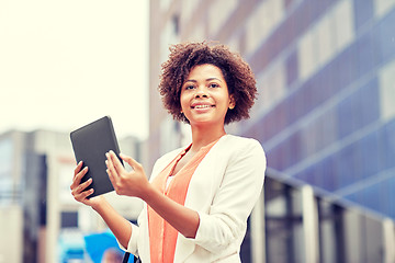 Image showing happy african businesswoman with tablet pc in city