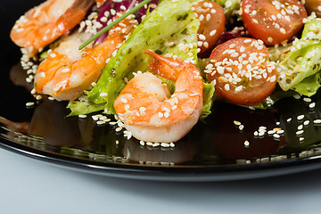 Image showing perfect dish with shrimps on a black plate. seafood