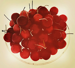 Image showing Sweet cherries on a plate. 3D illustration. Vintage style.