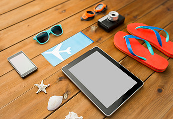 Image showing close up of tablet pc and travel stuff
