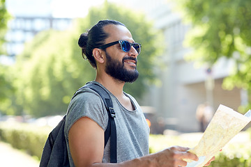 Image showing man traveling with backpack and map in city