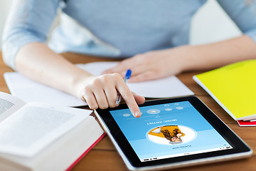 Image showing close up of student with tablet pc and notebook