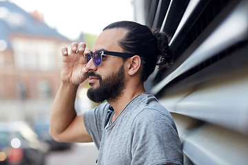 Image showing happy man with beard and sunglasses on city street