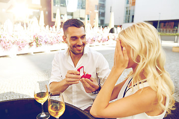 Image showing man with engagement ring making proposal to woman