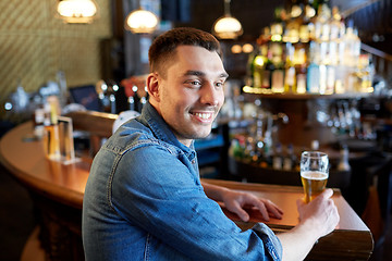 Image showing happy man drinking draft beer at bar or pub