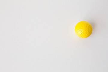 Image showing close up of yellow golf ball over white background