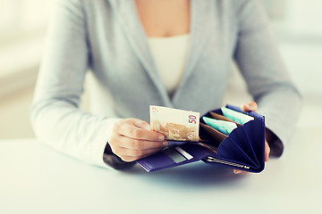 Image showing close up of woman hands with wallet and euro money