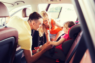 Image showing parents talking to little girl in baby car seat