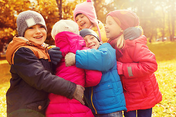 Image showing group of happy children hugging in autumn park