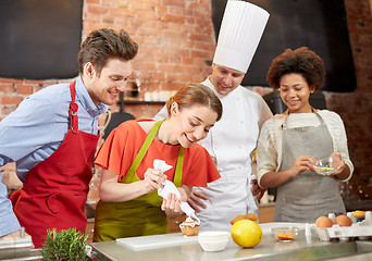 Image showing happy friends and chef cook baking in kitchen