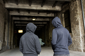 Image showing addict men or criminals in hoodies on street