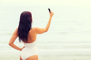 Image showing young woman taking selfie with smartphone